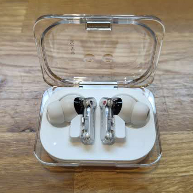 Nothing Ear review; white ear buds on a wooden table