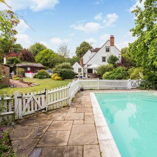 garden with swimming pool and wooden fence