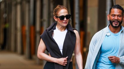 Jennifer Lopez wearing a white and black workout look with red sneakers in New York City July 2024