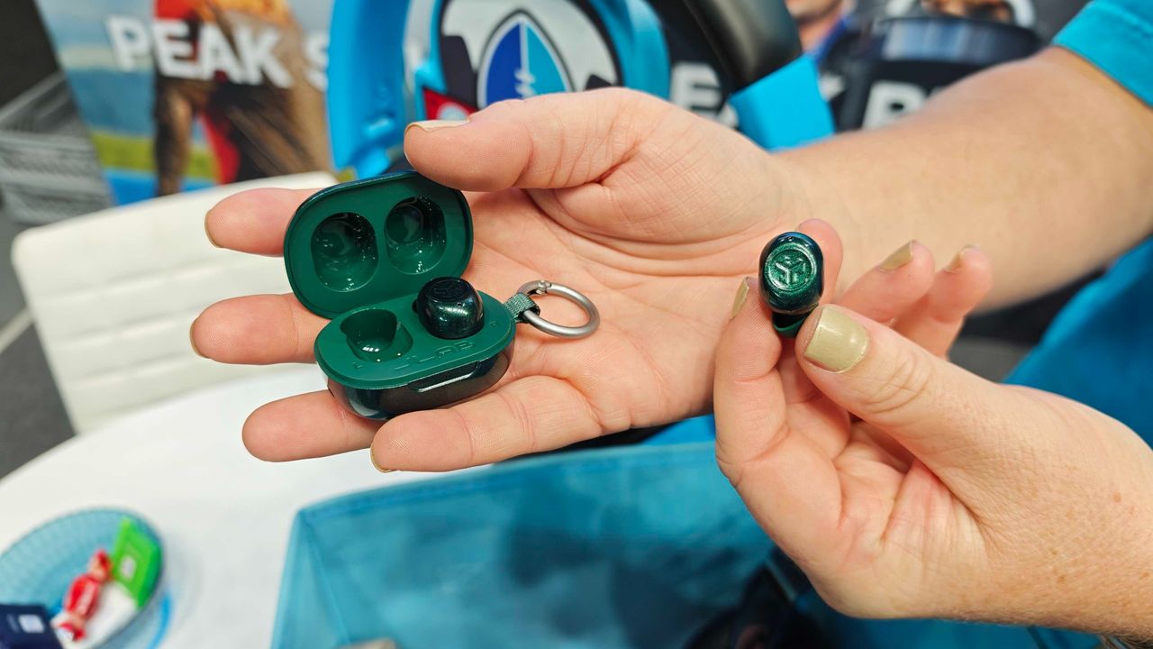 JLab's new earbuds at IFA, on a blue table