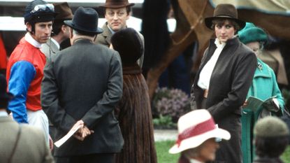Prince Charles, Prince of Wales (L), Andrew Parker Bowles (3rd L), Princess Margaret, Countess of Snowdon (C), Lady Diana Spencer (2nd R), wearing a brown suit by Bill Pashley and Queen Elizabeth The Queen Mother (R) stand in the parade ring at Sandown Park Racecourse on March 13, 1981 in Sandown, United Kingdom.