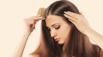 Model combing her hair - thinning hair