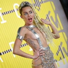 Miley Cyrus performs on stage in a chastity belt inspired outfit