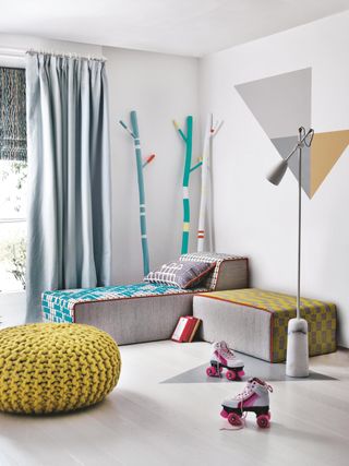 A small playroom with a tall floor lamp