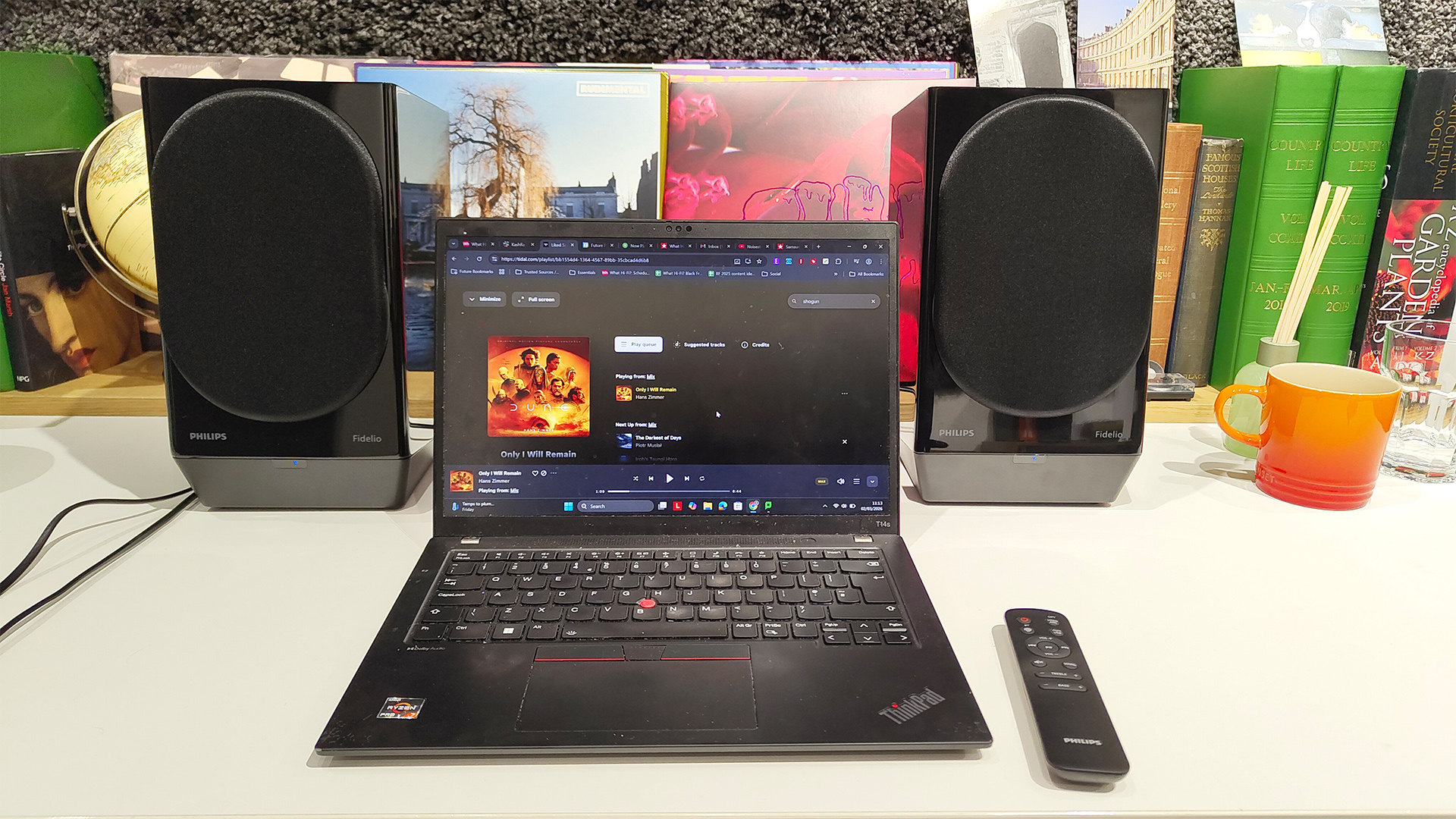 Philips Fidelio FA3 desktop speakers with laptop and remote on white desk