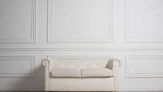 White wood panelled wall and sofa
