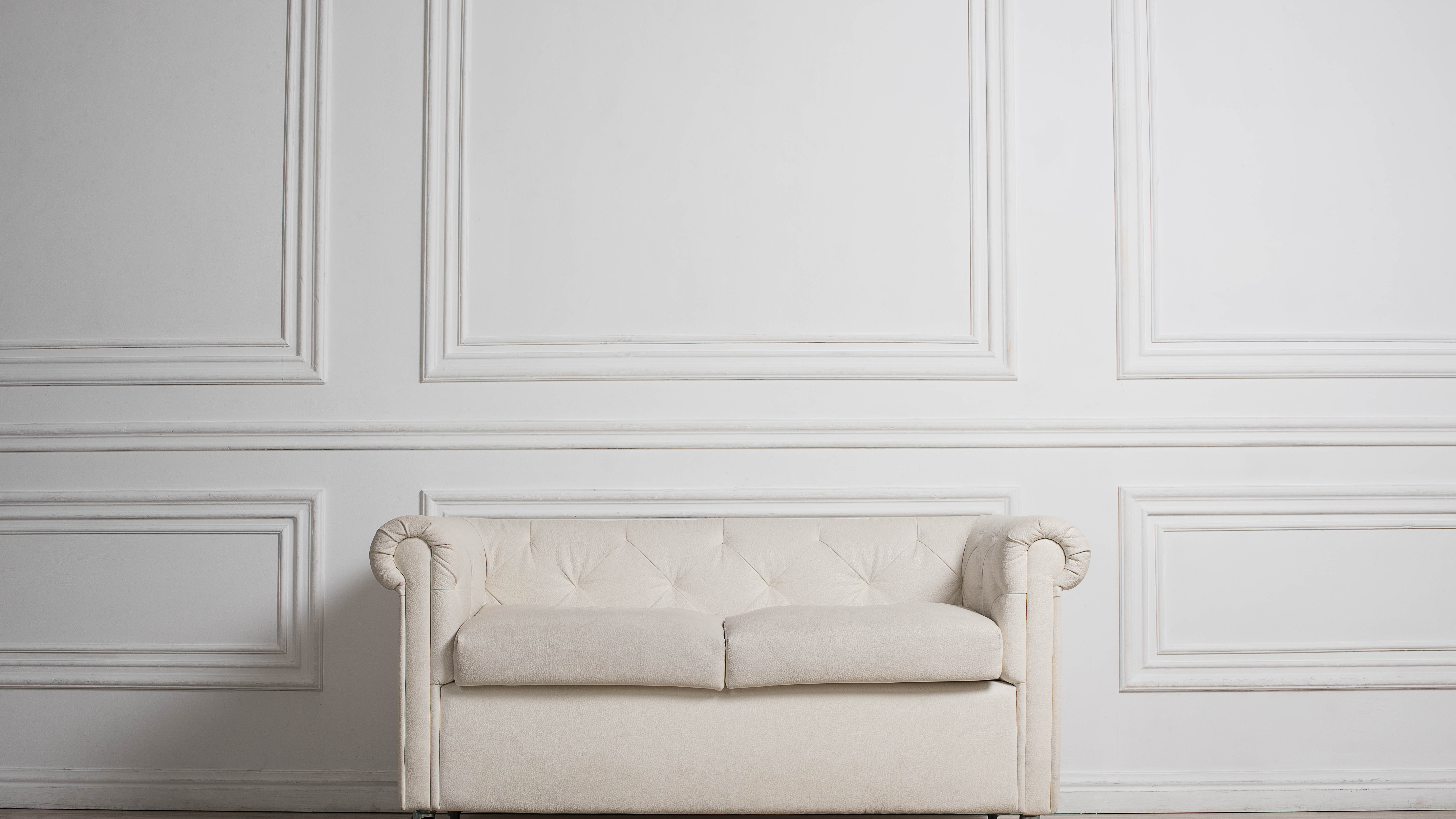 White wood panelled wall and sofa