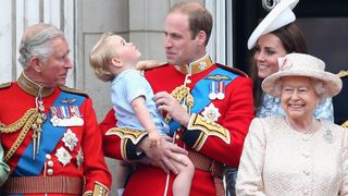 Prince George of Cambridge is held by Prince William, Duke of Cambridge and Catherine, Duchess of Cambridge, Prince Charles, Prince of Wales and Queen Elizabeth II look out on the balcony of uckingham Palace during the Trooping the Colour