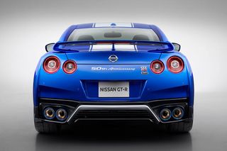 Nissan GT-R in bright blue, photographed from behind on a gray background.