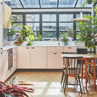 pink kitchen with glass roof extension and cork flooring