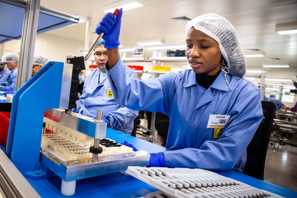 Amployees work on the production line of a COVID-19 coronavirus home test unit