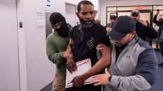 A Jamaican man is detained by federal agents after his immigration court hearing at the Ted Weiss Federal Building on June 9, 2025 in New York City. Federal agents are arresting immigrants during mandatory check-ins, as ICE ramps up enforcement following immigration court hearings