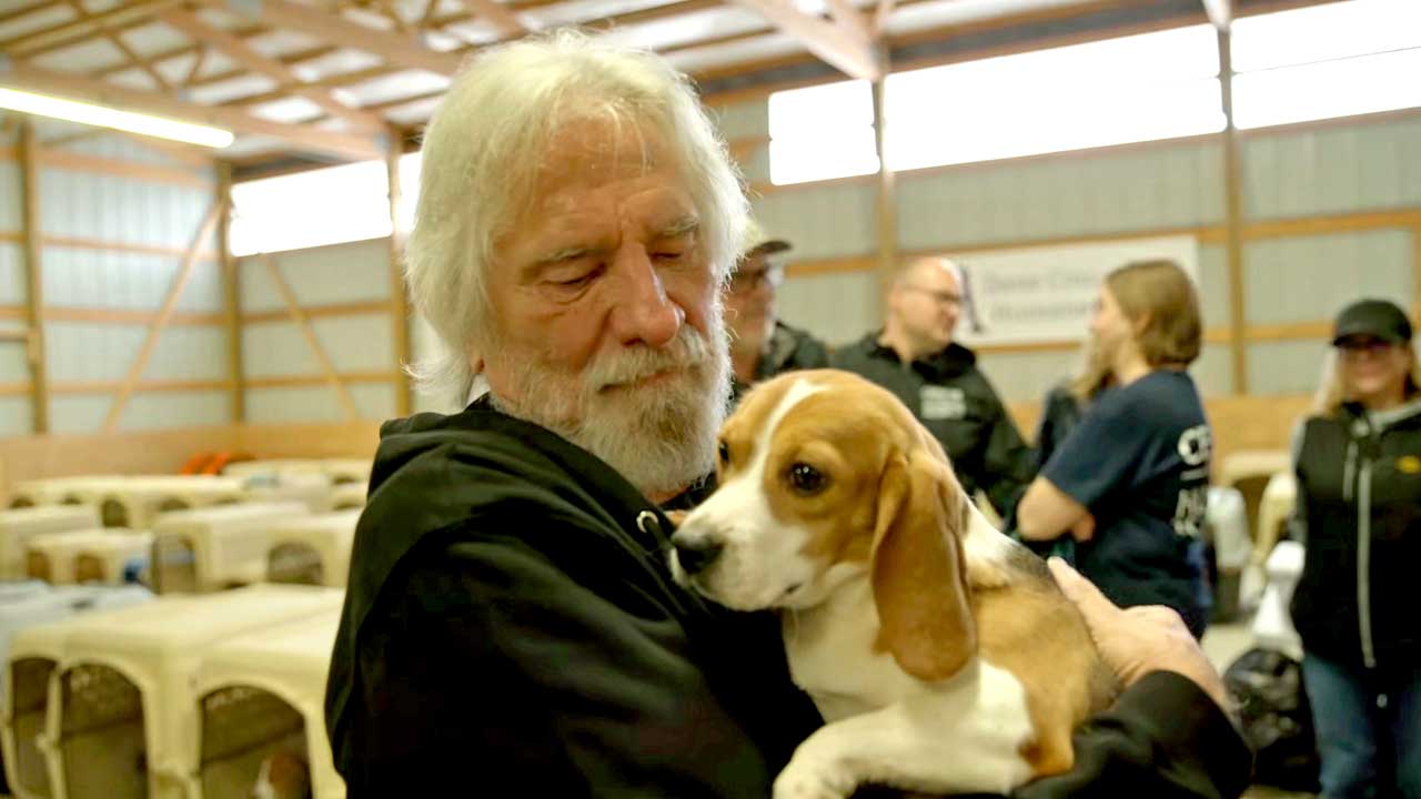 Geezer Butler cradling a beagle