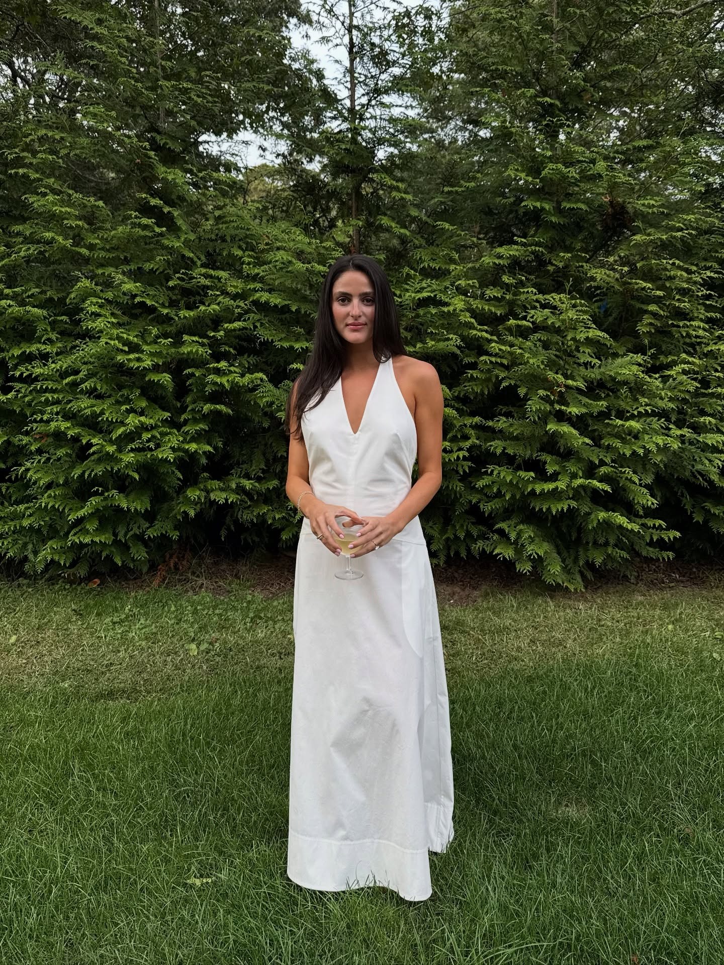 Woman wearing white bridal bachelorette outfit.