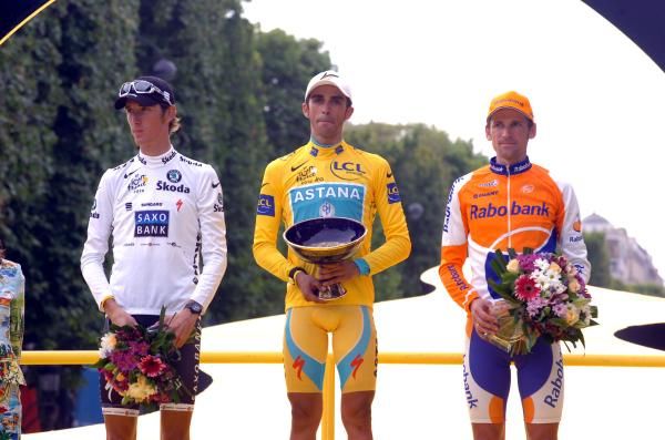 To the winner the spoils: Alberto Contador (Astana) ahead of a glum-faced Andy Schleck (Saxo Bank) and Denis Menchov (Rabobank)