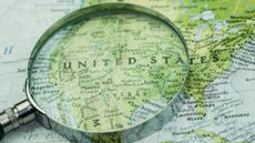 A map of the USA under a magnifying glass.