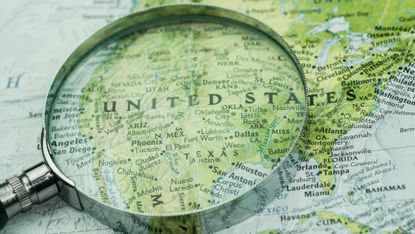 A map of the USA under a magnifying glass.