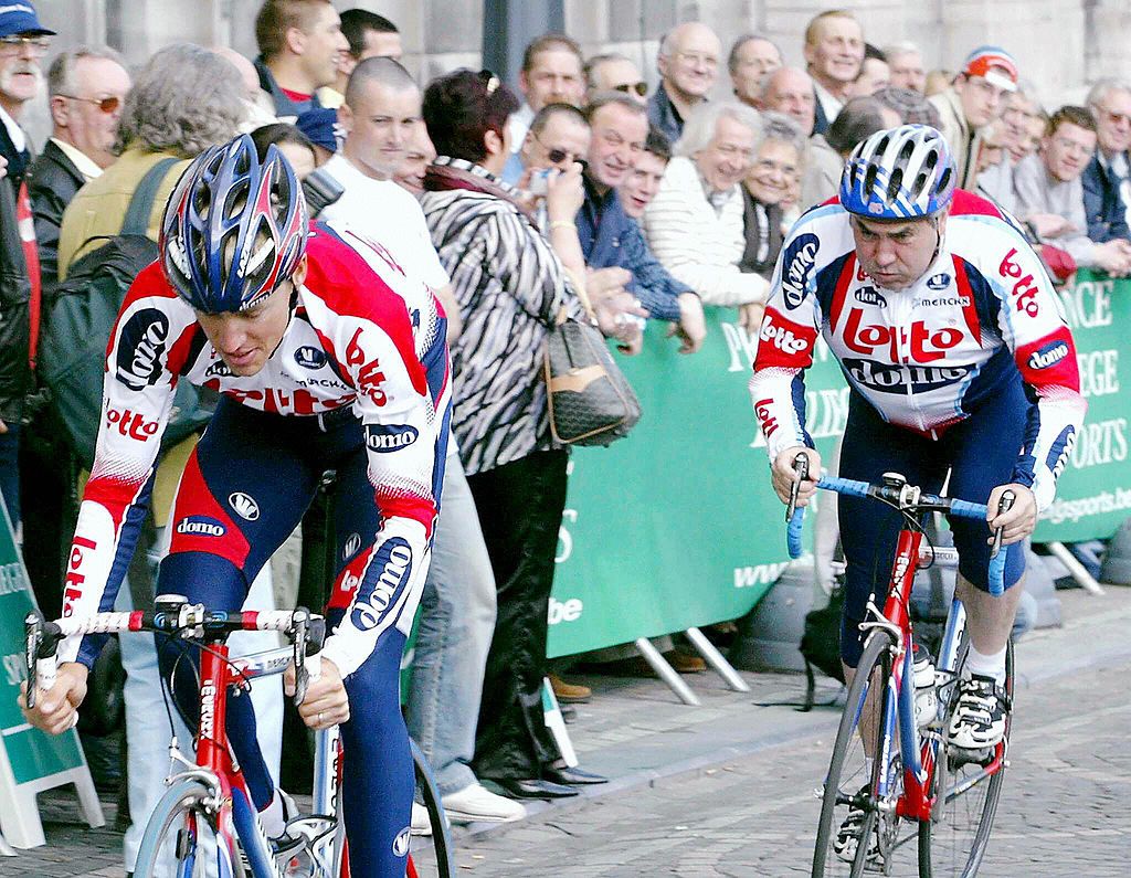 LIEGE BELGIUM Belgian cycling champion Eddy Merckx R and his son Axel L ride during a time trial for the benefit of the Childs Cardiology Research Centre 23 April 2004 in Liege AFP PHOTO BELGAMICHEL KRAKOWSKI Photo credit should read MICHEL KRAKOWSKIAFP via Getty Images