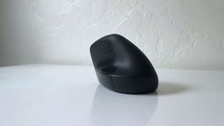 The HP 925 ergonomic vertical mouse on a white desk
