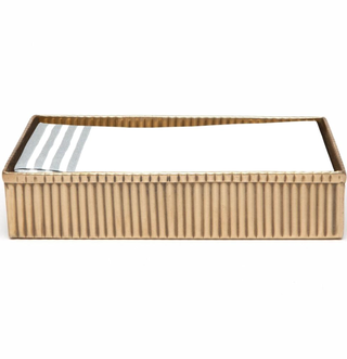 ribbed brass tray holding folded up hand towels