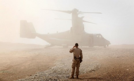 A marine awaits Secretary of Defense Leon Panetta's arrival in Afghanistan Wednesday.