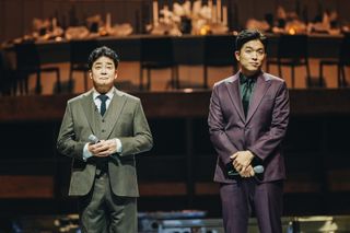 'Culinary Class Wars' judges Paik Jong-won and Ahn Sung-jae stand on the reality show's set holding microphones.