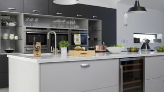 black and grey kitchen with glass fronted cabinets with smart lights