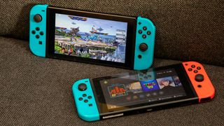 Nintendo Switch deals: two Nintendo Switches on a sofa