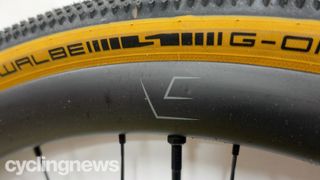 A close up of VeloElite Carbon 350 Gravel disc wheels, showing the VE logo on the sidewall and the Schwalbe G-One tyre fitted