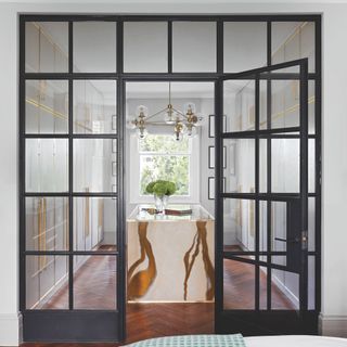 Black metal frame Crittall-style internal door and fixed glazing between rooms