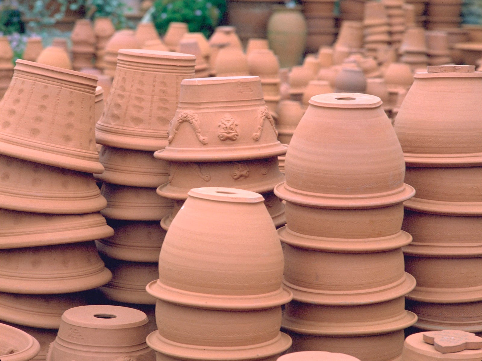 Collection of stacked terracotta pots at Whichford Pottery, UK