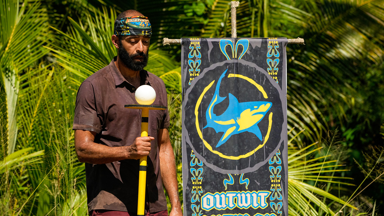 Nate Moore in his buff with a big beard competing in Survivor 49 challenge.