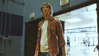 Sean Patrick Small as Larry Bird walking onto basketball court in jeans in Winning Time season 2 episode 3