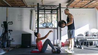 two people working out in a home gym