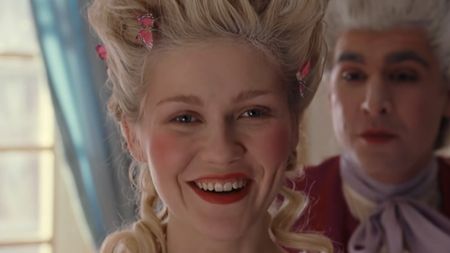 Kirsten Dunst as Marie Antoinette smiling in her new wig. 