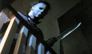 Halloween Michael Myers wielding a knife by the railing