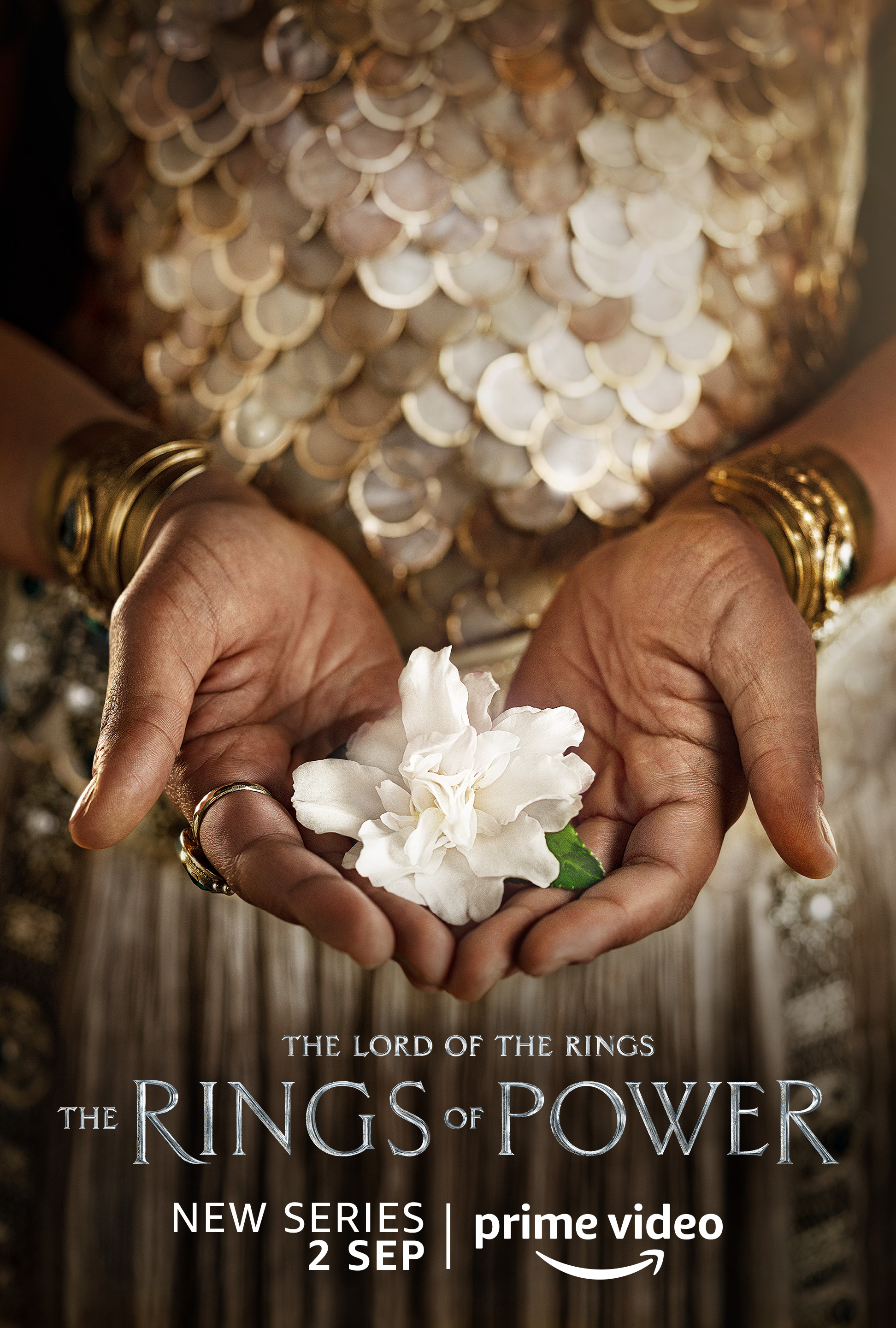 A female holding a flower character poster for Lord of the Rings: The Rings of Power