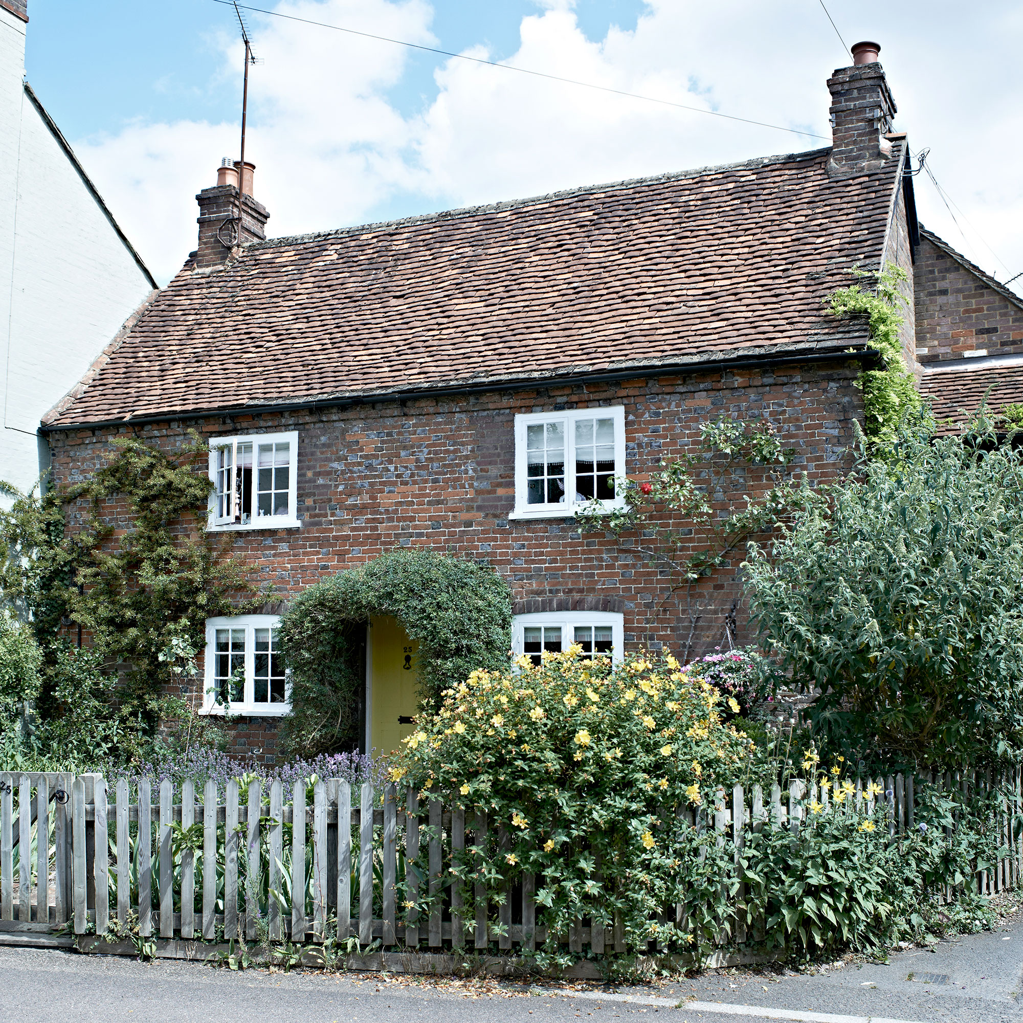 Cottage with pergola and fence