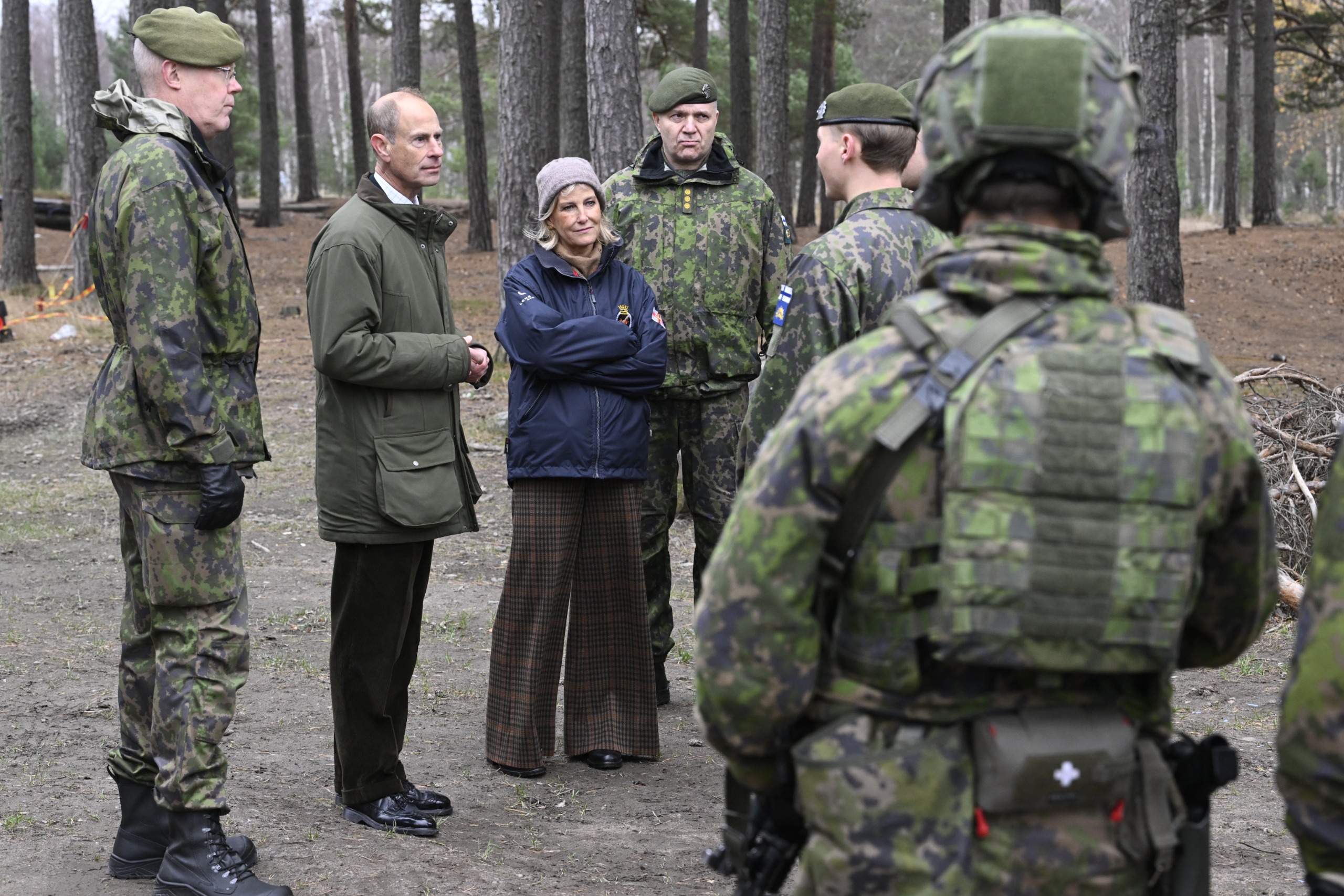 Duchess Sophie and Prince Edward talking to soldiers in the woods