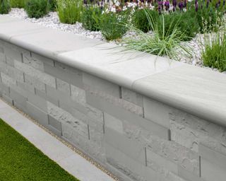 low garden wall made from composite stone in modern garden