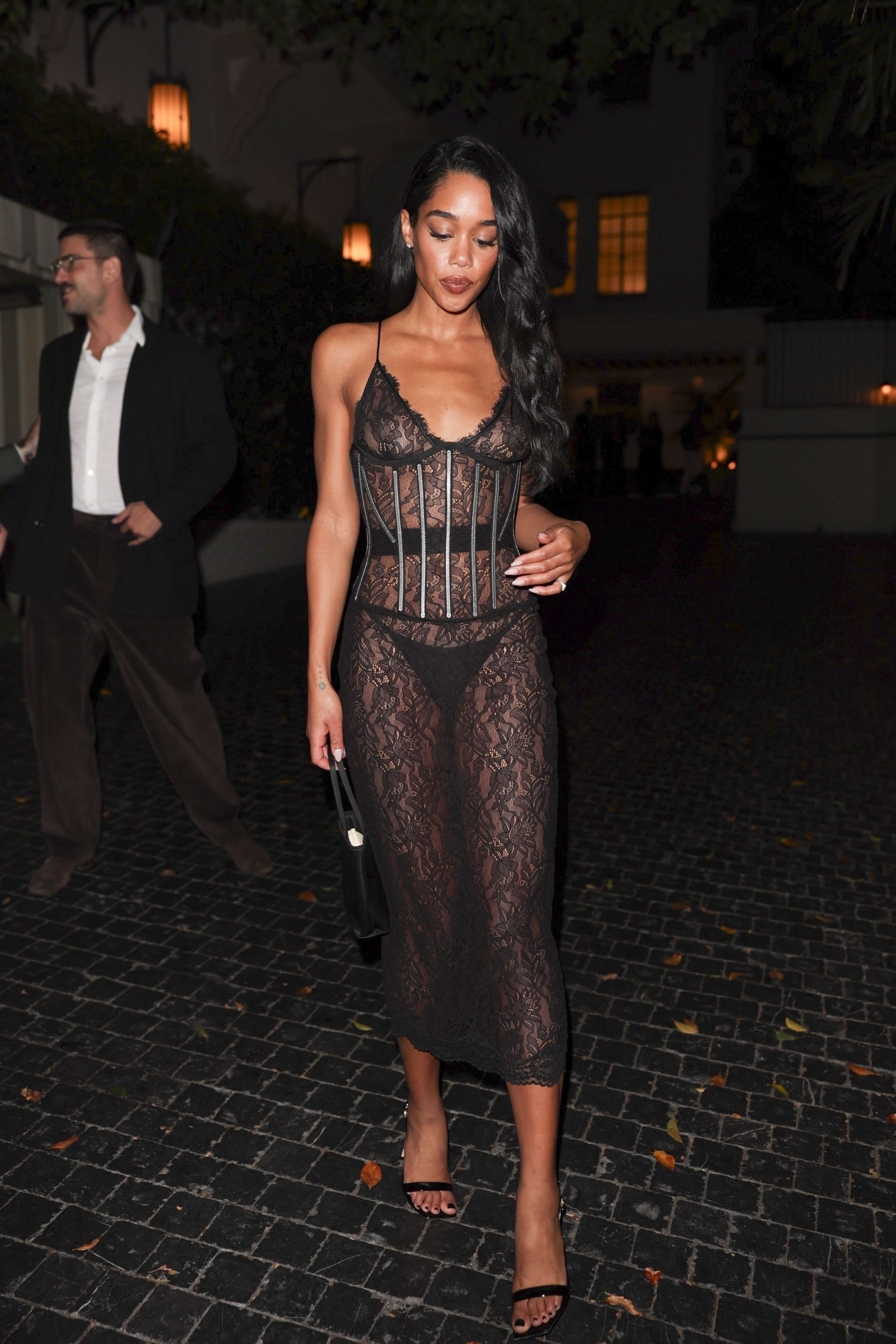 American actress and model Laura Harrier was seen attending the Giorgio Armani after-party at the Chateau Marmont in Los Angeles. She is wearing a black sheer lace dress by Dolce & Gabbana.