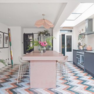 kitchen with white walls wooden flooring dinning table with chair kitchen platform