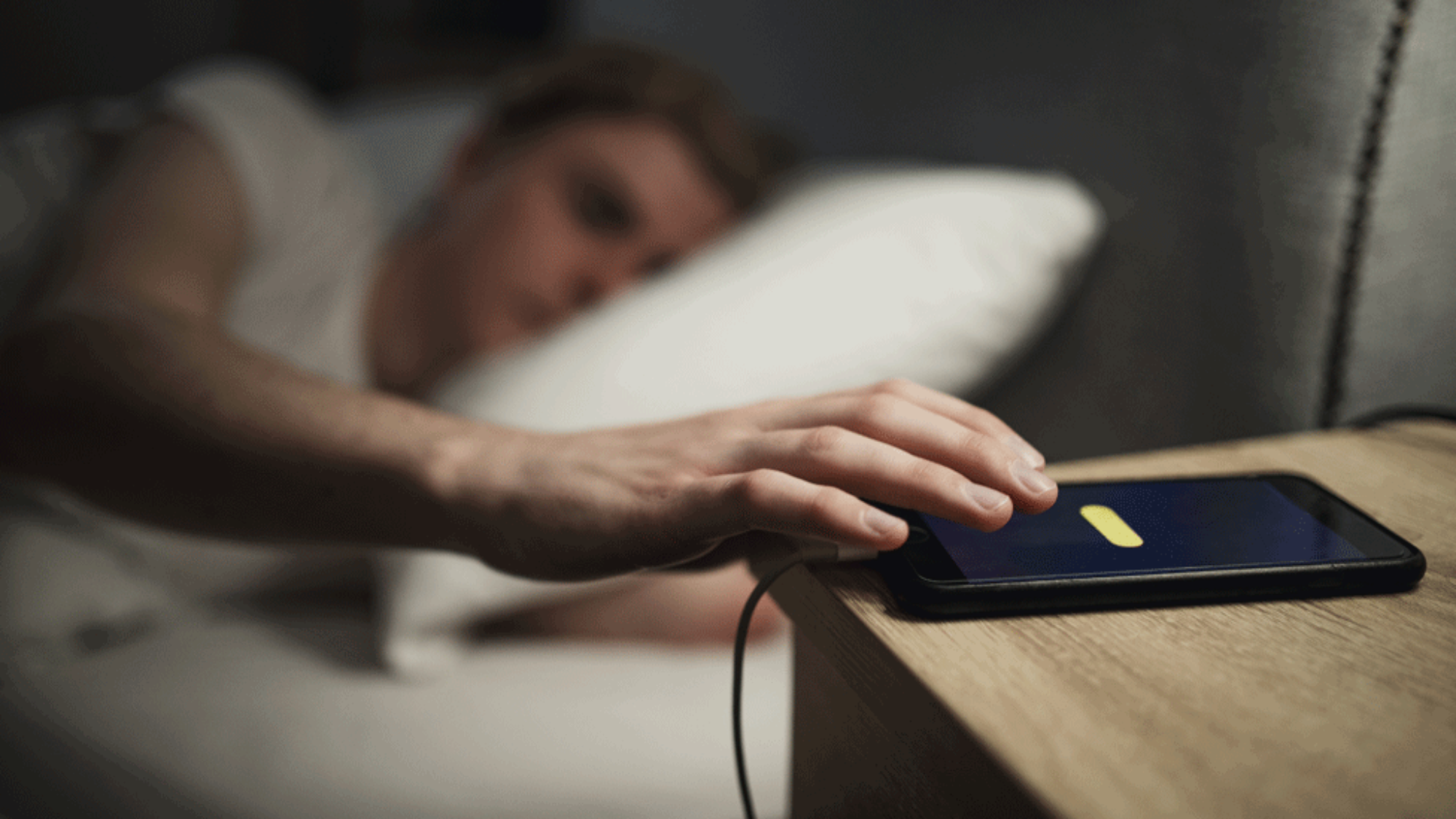 Man snoozing alarm