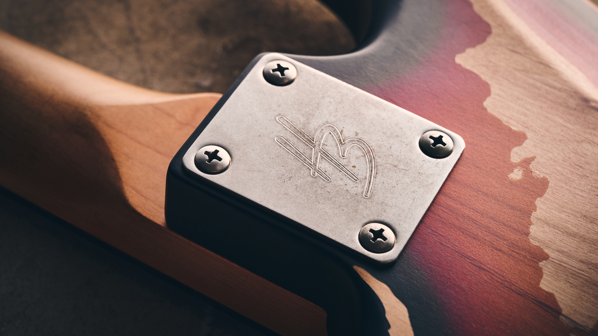 Close up of the distressed neck plate of a Harley Benton ST-62HA electric guitar