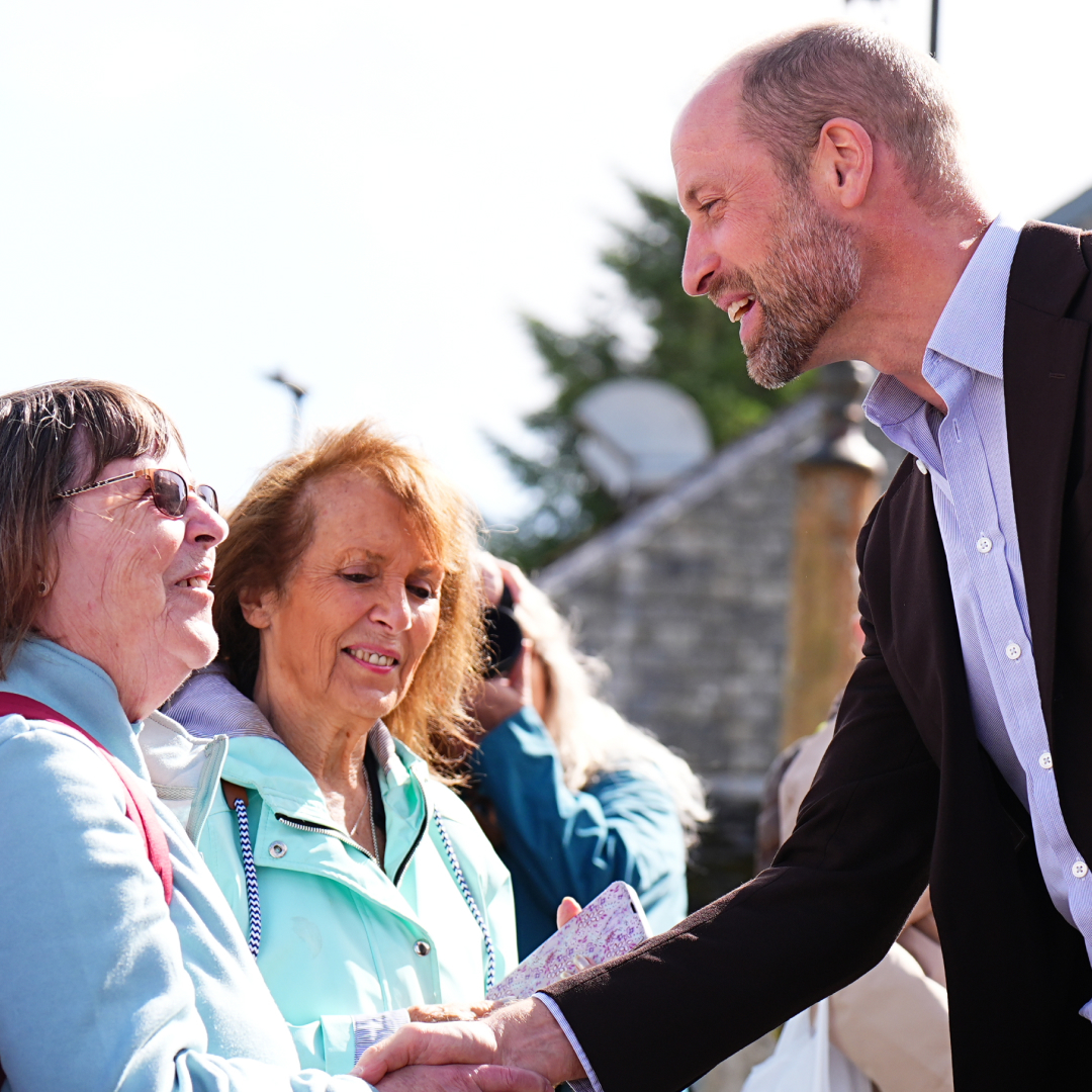 Prince William shaking hands with a woman
