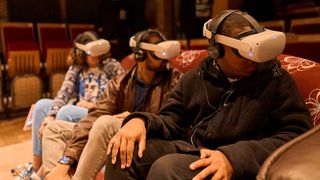 Amma at Tara theatre, three guests wearing VR headsets