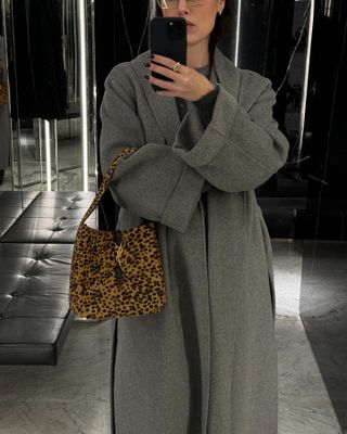 Influencer carrying a leopard-print bag.