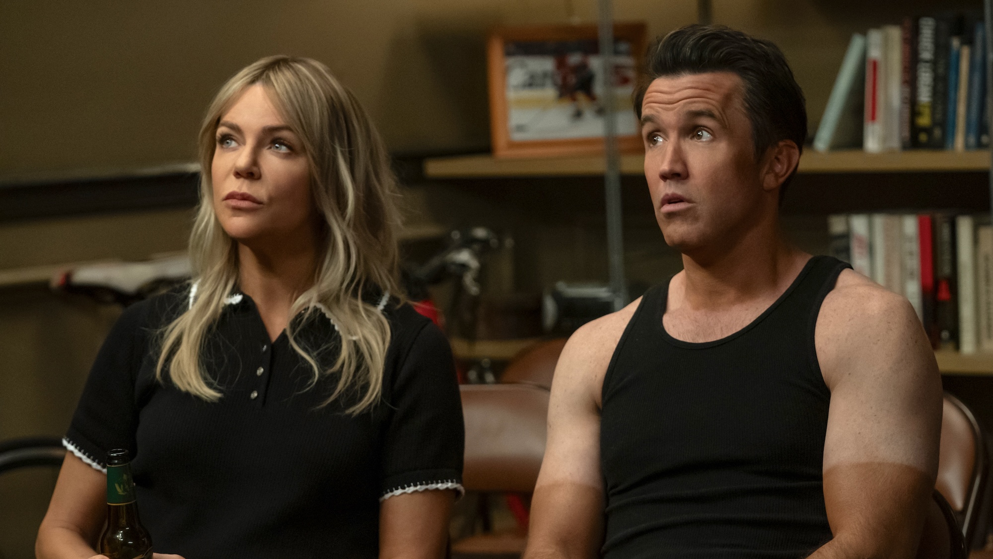 Dee sitting next to Mac in sleeveless tank top with extremely pale shoulders compared to extremely tanned forearms in It's Always Sunny in Philadelphia Season 17