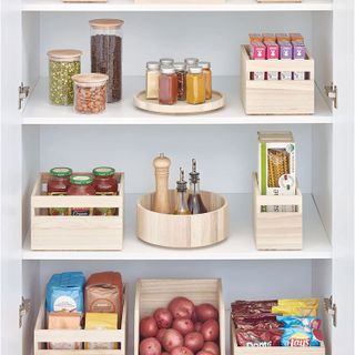 pantry with wooden storage baskets and storage turntables