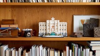 Lego Trevi Fountain on a shelf beside various artefacts